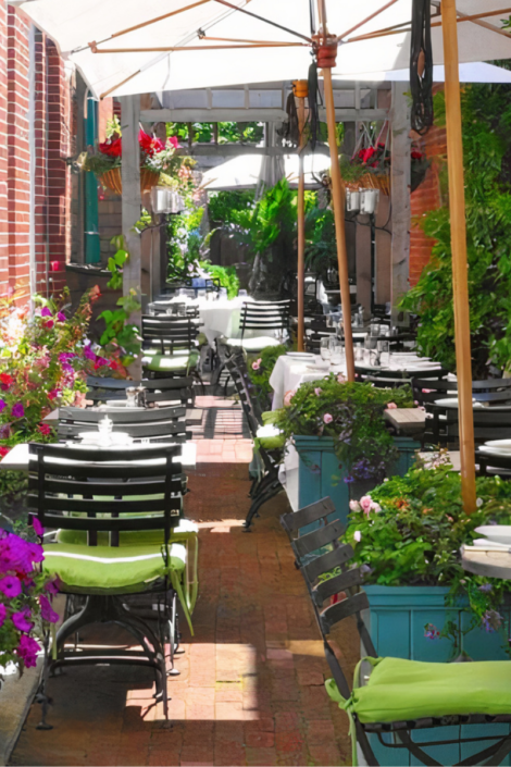 Outdoor seating at St. Ambreous in Aspen, offering a Palm Beach dining experience.